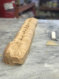 a long piece of peanut butter sitting on a counter